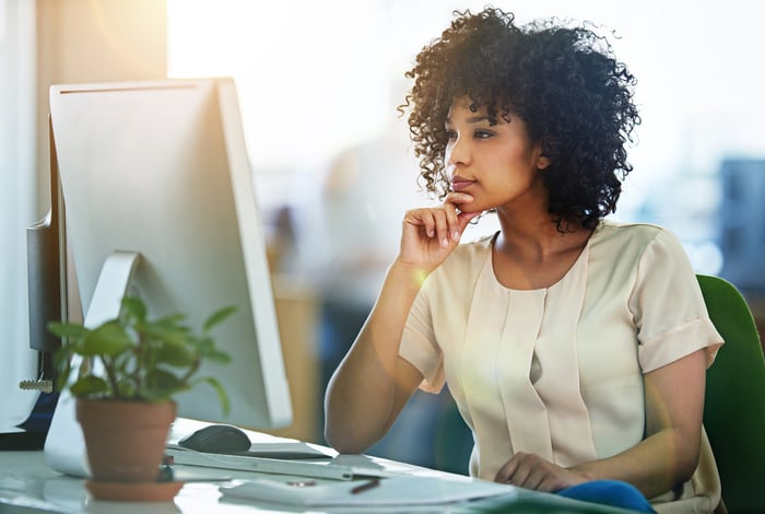 Office worker staring at computer screen.