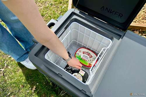 Removing an ice cream container from the Anker EverFrost Dual-Zone Powered Cooler 50