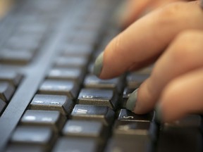 A woman types on a keyboard in New York on&ampnbsp;Tuesday, Oct. 8, 2019. Fewer than half of Canadians believe the federal government's plan to regulate social media sites will make platforms safer, a new survey suggests.THE CANADIAN PRESS/AP, Jenny Kane