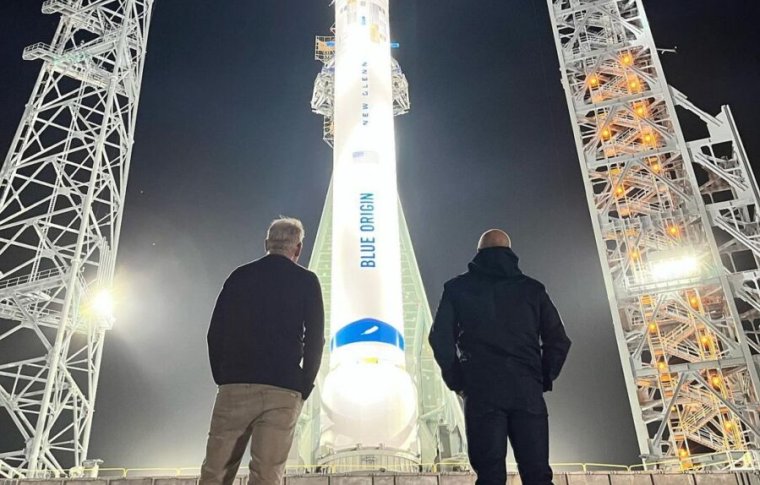 Dave Limp, Blue Origin's new CEO, and founder Jeff Bezos observe the New Glenn rocket on its launch pad Wednesday at Cape Canaveral Space Force Station, Florida.