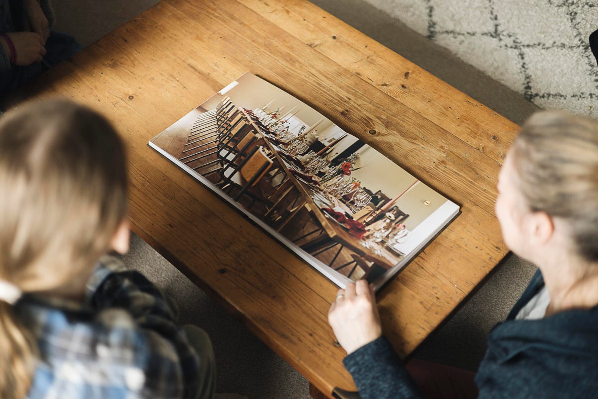 Image showing people looking through a photobook.