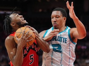 Toronto Raptors guard Immanuel Quickley is fouled.