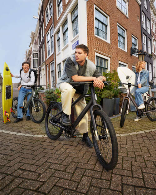 Three people on Cowboy bikes in Amsterdam