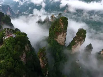 Die Luftaufnahme von den in Wolken gehüllten Berge am Dorf Huangshi in Zhangjiajie.