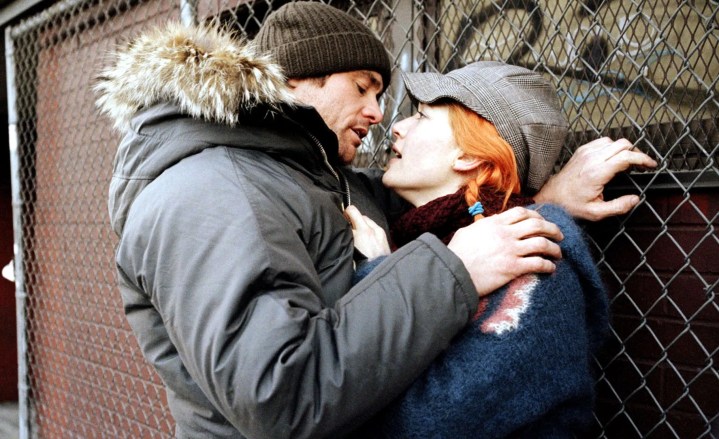 A man and a woman stare at each other in Eternal Sunshine of the Spotless Mind.