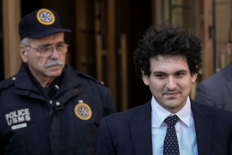 FTX founder Sam Bankman-Fried (R) departs Manhattan Federal Court after an arraignment hearing on March 30, 2023, in New York City. 