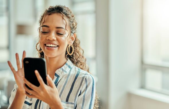 Woman smiling at her phone