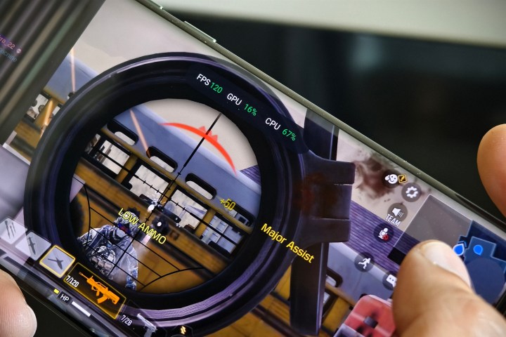 OnePlus 12 held in person's hand running Call of Duty Mobile.