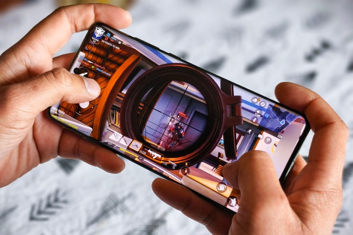 OnePlus 12 held in person's hand running Call of Duty Mobile.