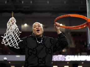 South Carolina head coach Dawn Staley celebrates cutting the net.