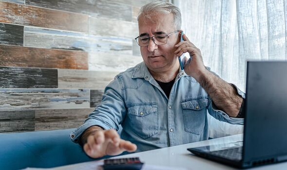 Man calculating finances at home