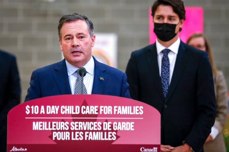 Prime Minister Justin Trudeau, right, looks on as as Alberta Premier Jason Kenney makes a child-care announcement in Edmonton on Nov. 15, 2021.