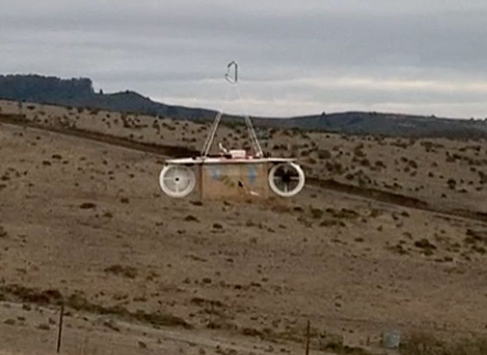 An object in the air in a barren landscape.