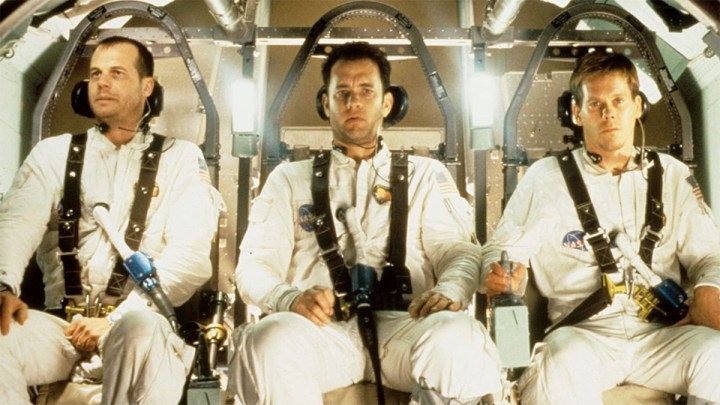 Three astronauts are strapped into a spaceship.