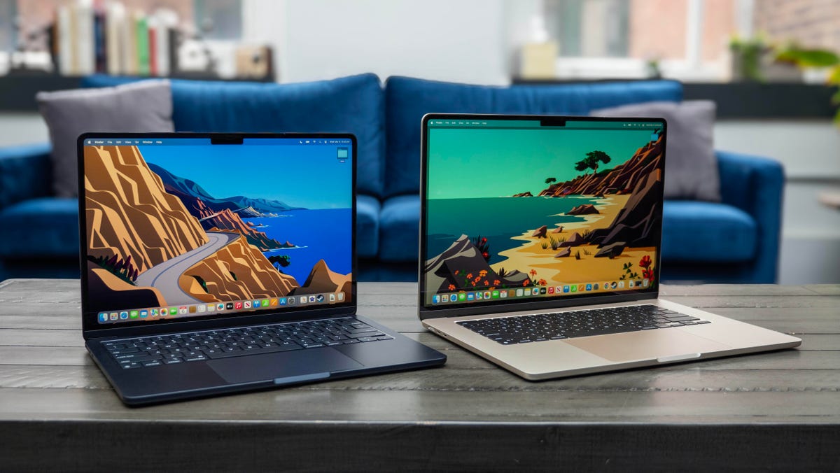 Apple MacBook Air M3 13-inch laptop on a wood table with windows in the background.