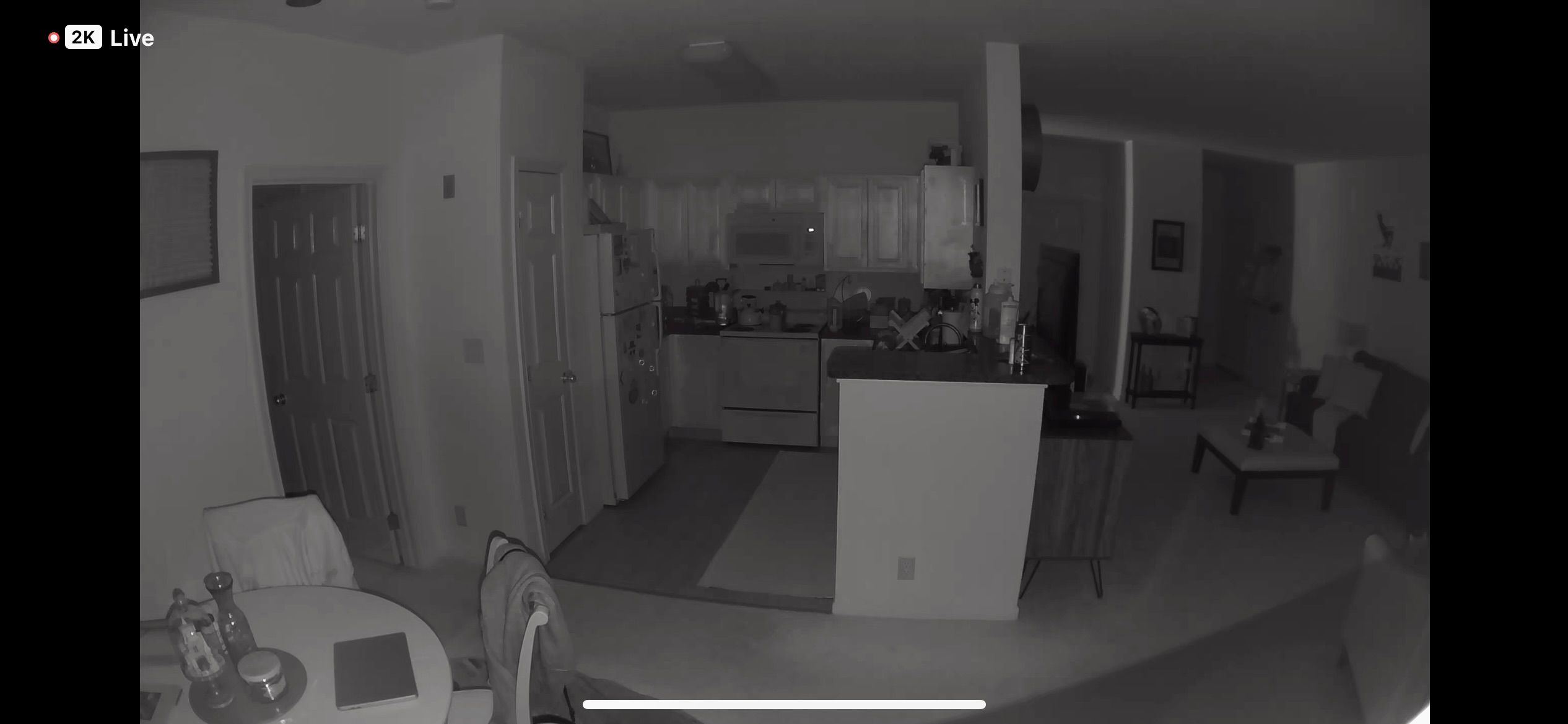 Dining room, kitchen, and living room infrared imagery captured by the Arlo Essential Indoor Cam (2K)