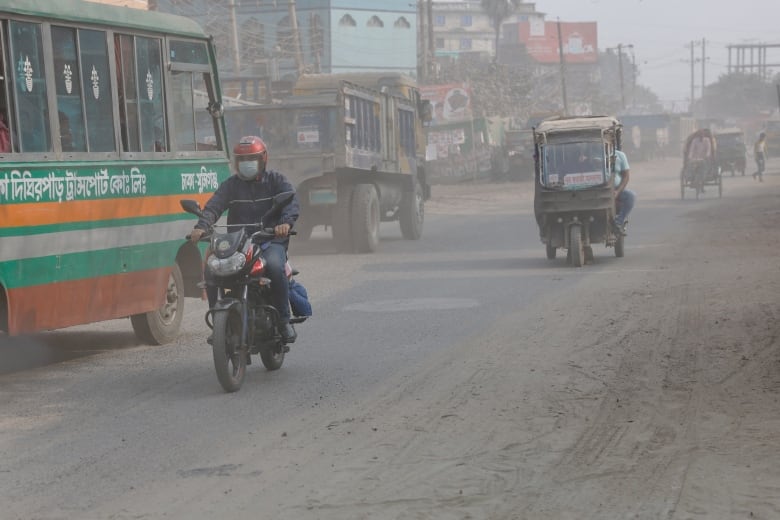 Vehicles move through the dusty road as air quality decreases during the dry season in Dhaka, Bangladesh, February 19, 2024. 