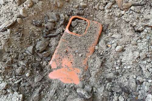 Bellroy Bio Phone Case buried in dirt