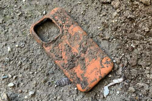 Bellroy Bio Phone Case in dirt after being buried for five months