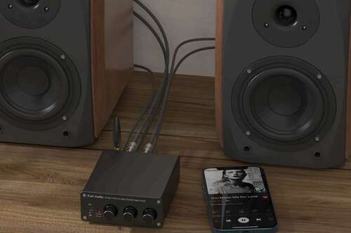 Fosi Audio BT20A in front of speakers