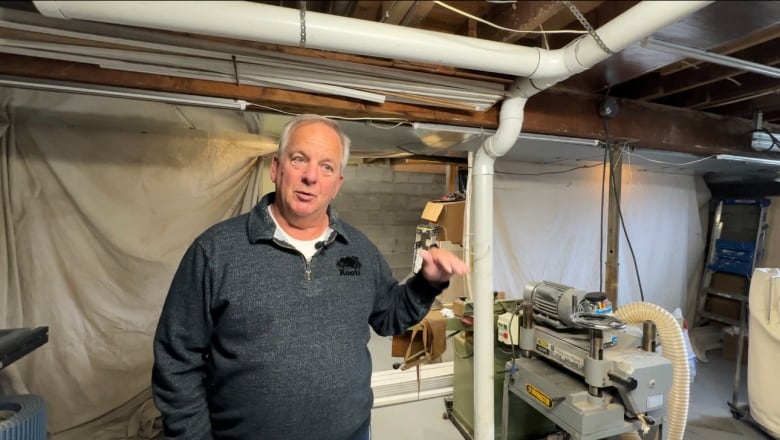 Bob barnes stands next white tubing in his basement