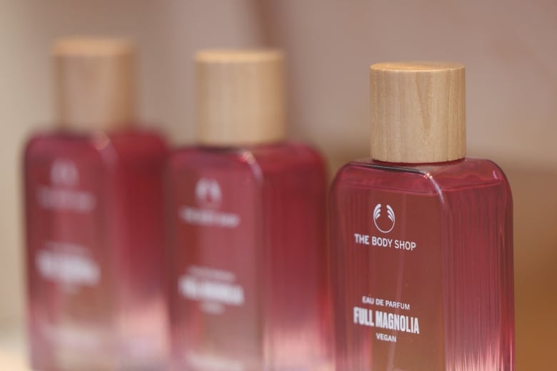 Three pink bottles with The Body Shop logo are shown in close-up.