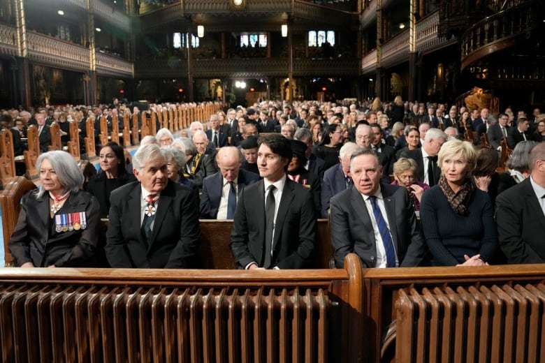 Prime Minister Justin Trudeau, centre, sits in a front row of Notre-Dame Basilica in Montreal.