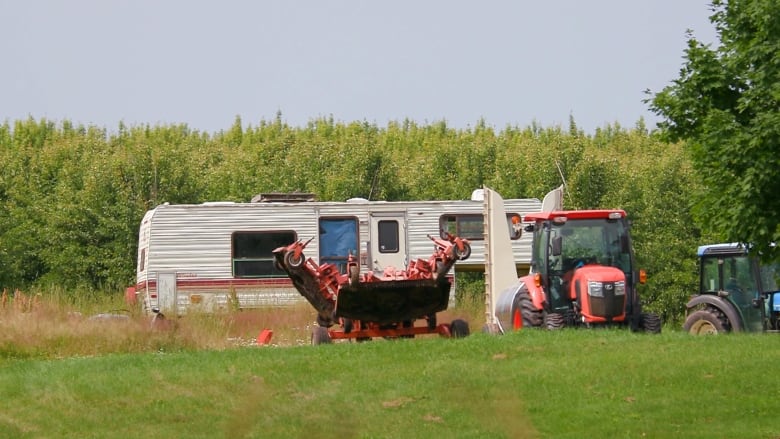 An RV and some farm equipment sits on the Canadian Nectar Farm in Alliston, P.E.I. in July 2023.