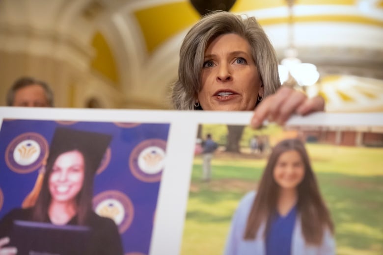 Woman holds two portrait photos next to each other