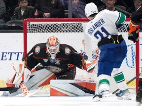 Nils Hoglander, right, scores on Anaheim Ducks goaltender Lukas Dostal during the first period on Sunday in Anaheim.