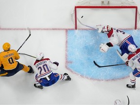 Predators' Filip Forsberg scores past diving Canadiens goaltender Jake Allen, while Juraj Slafkovsky and Mike Matheson watch helplessly Tuesday night in Nashville.