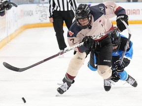 Montreal's Laura Stacey skates away from Toronto's Jocelyne Larocque.