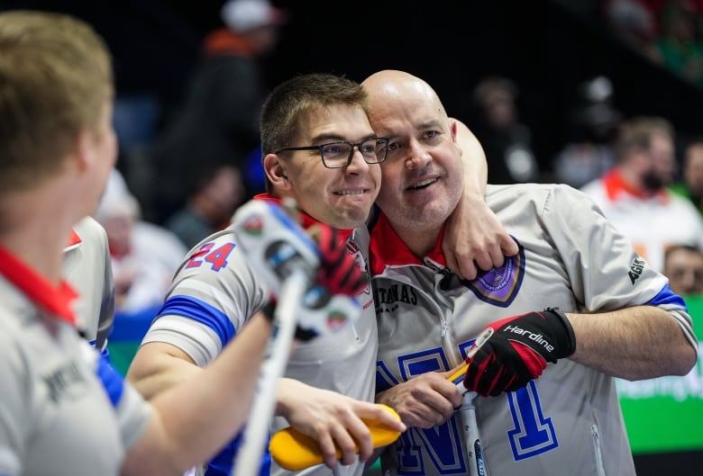 The curling skip from Northwest Territories is embraced by his second after a big win at the Brier.