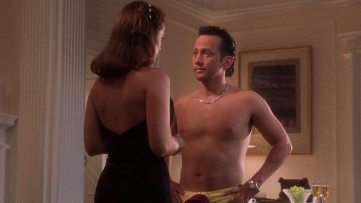 Rob Schneider shirtless standing in front of a taller woman in a scene from Deuce Bigalow: Male Gigolo.