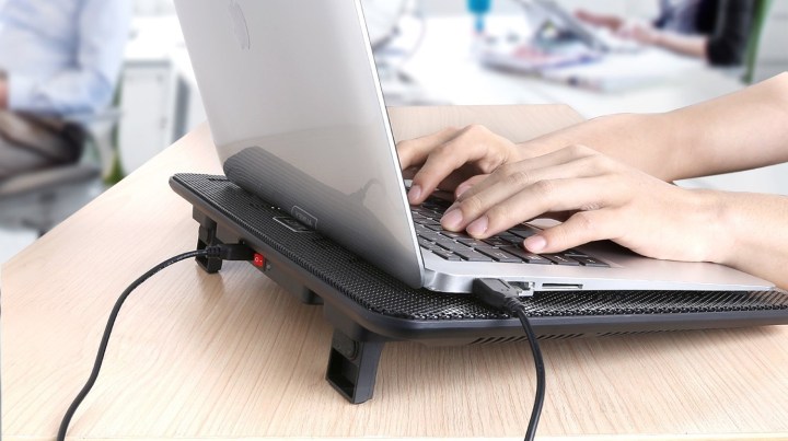 A laptop with a cooling pad.