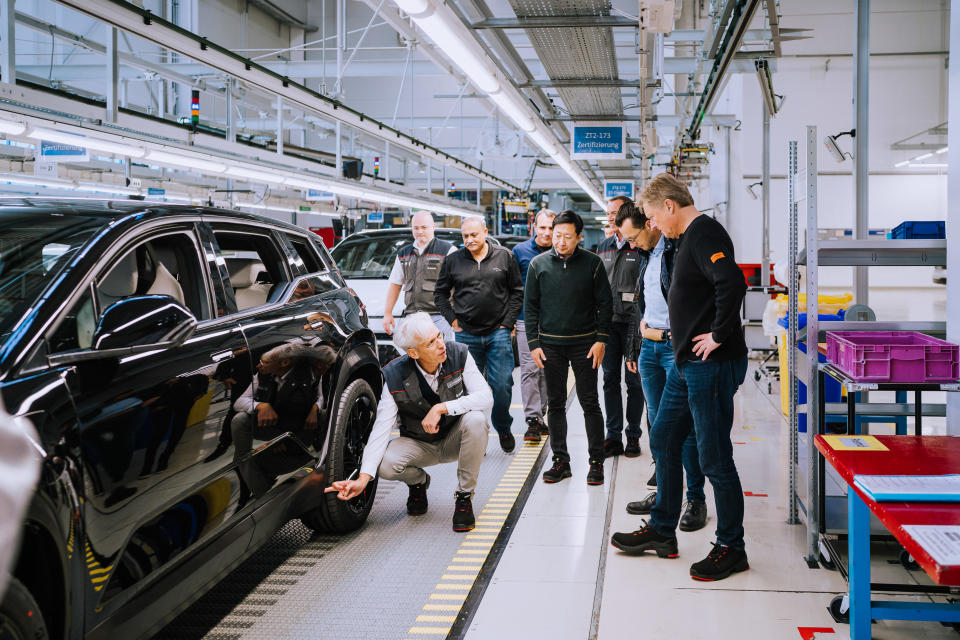 Examining an Ocean SUV at Fisker's factory.