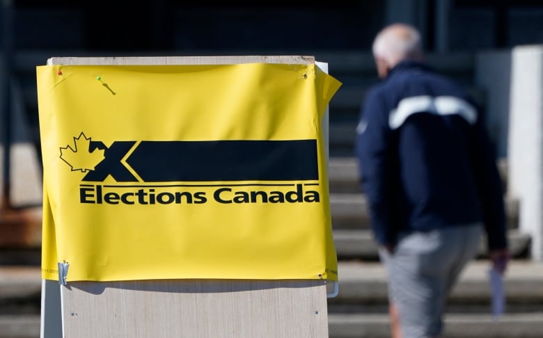 A yellow sign with black text that reads 'Elections Canada.' 