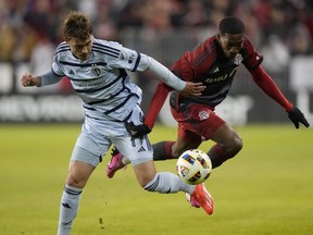 Toronto FC forward Prince Osei Owusu (99) and Sporting Kansas City midfielder Jake Davis (17) battle for the ball during first half MLS action in Toronto on Saturday, March 30, 2024.