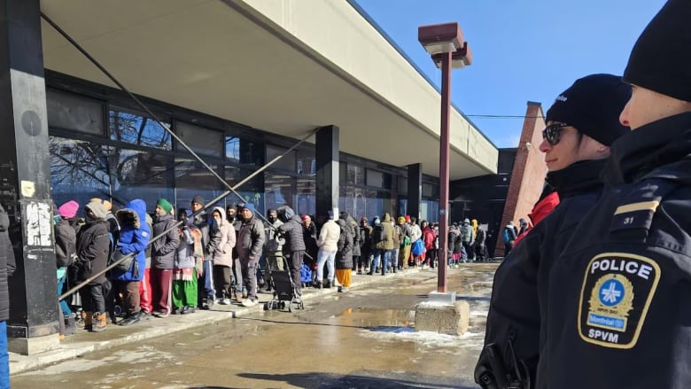 People stand in line outside.