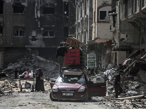 Displaced Palestinians prepare to transport their belongings