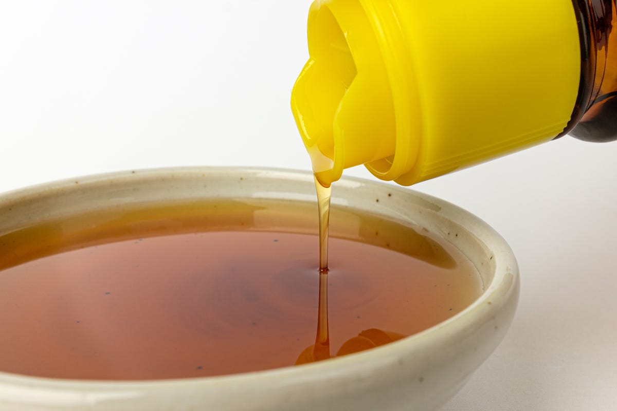 Sesame oil pouring into a small dish.