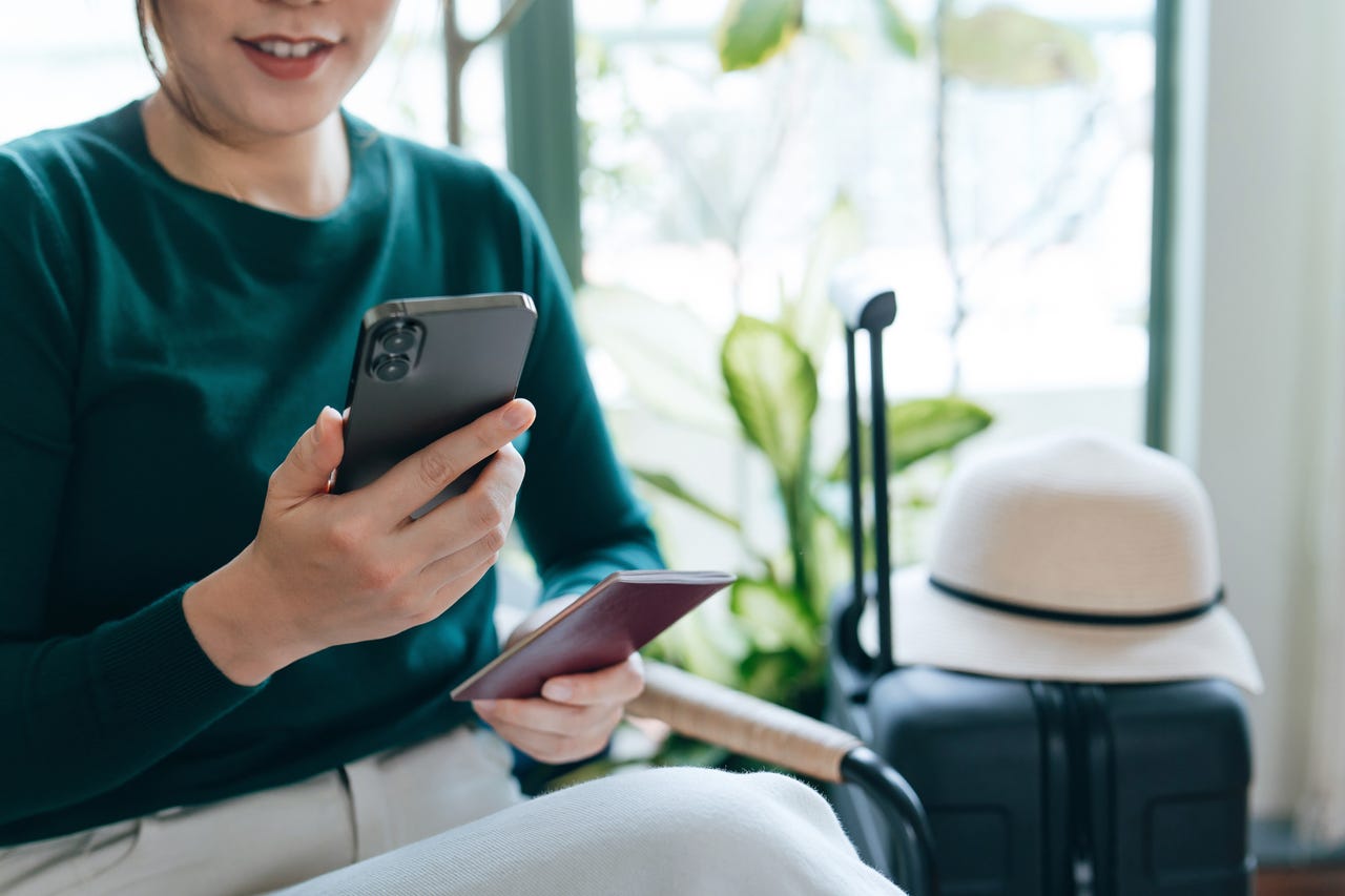 woman traveling with phone and passport