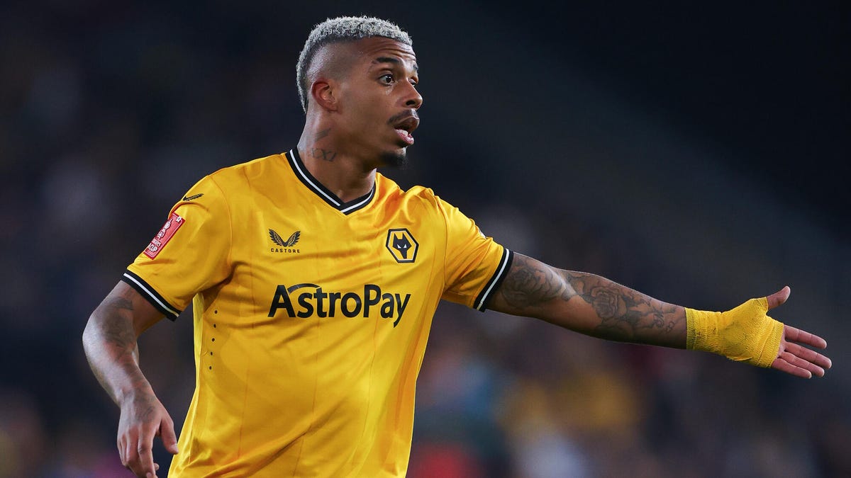 Wolves forward Mario Lemina standing with his left hand outstretched.