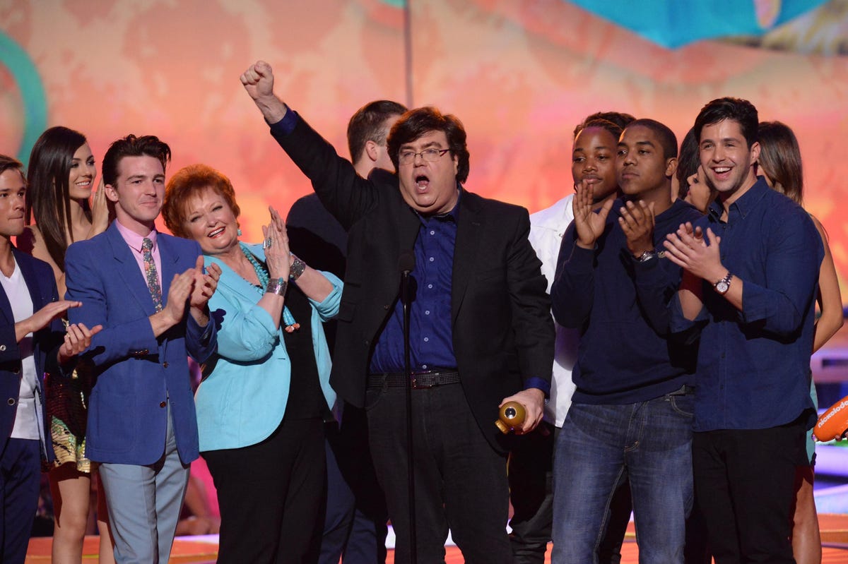 dan-schneider and nickelodeon show cast members stand on stage