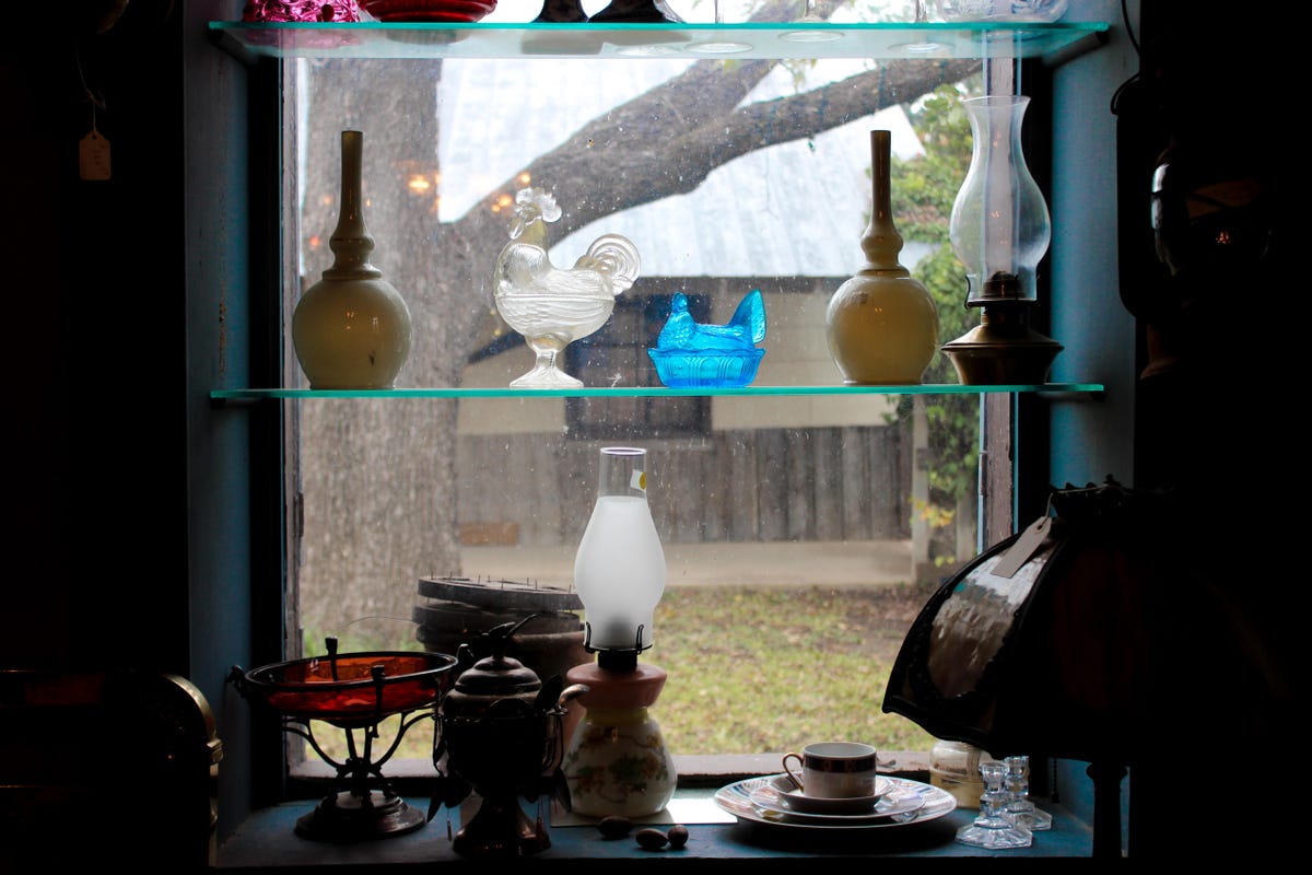 Beautiful trinkets displayed in the window of an antique shop.