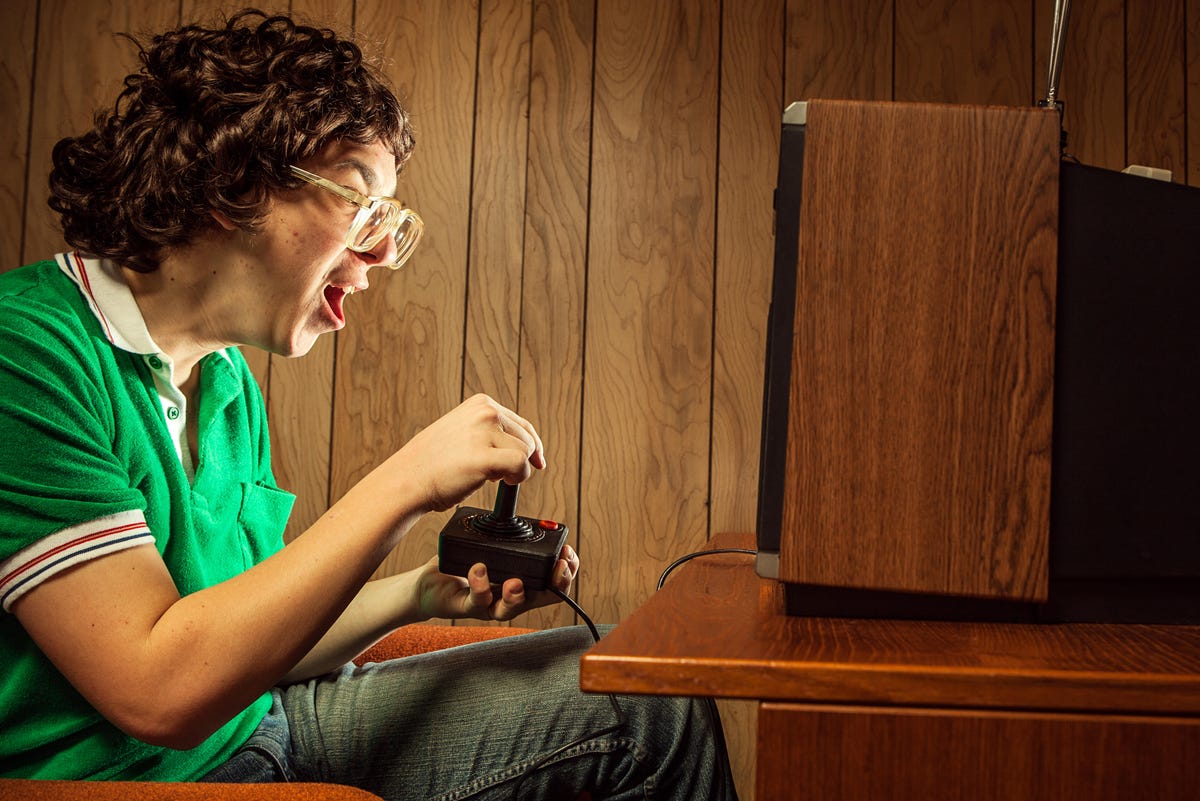 An enthusiastic gamer in front of a CRT TV.