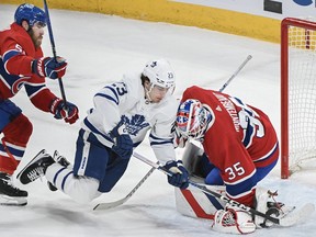 Toronto Maple Leafs' Matthew Knies (23) moves in on Montreal Canadiens goaltender Sam Montembeault as Canadiens' David Savard defends during first period NHL hockey action in Montreal, Saturday, March 9, 2024.