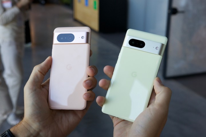 The Google Pixel 8 and Google Pixel 7 being held next to each other.