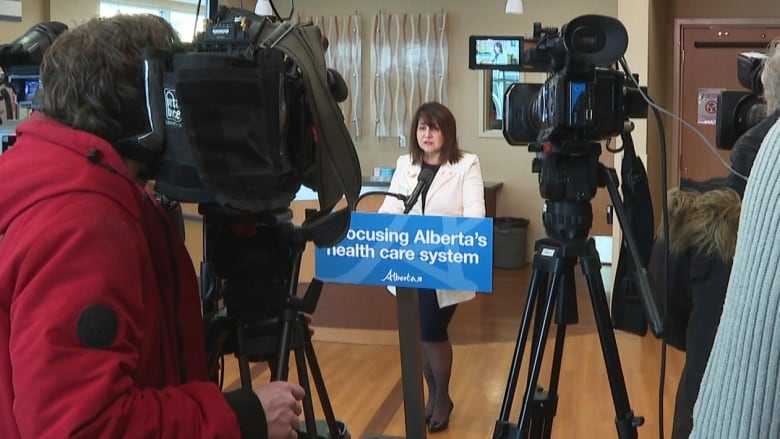 Alberta's health minister holds a press conference.