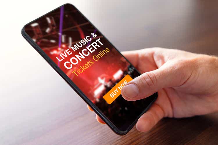 Person buying music concert tickets online on mobile phone